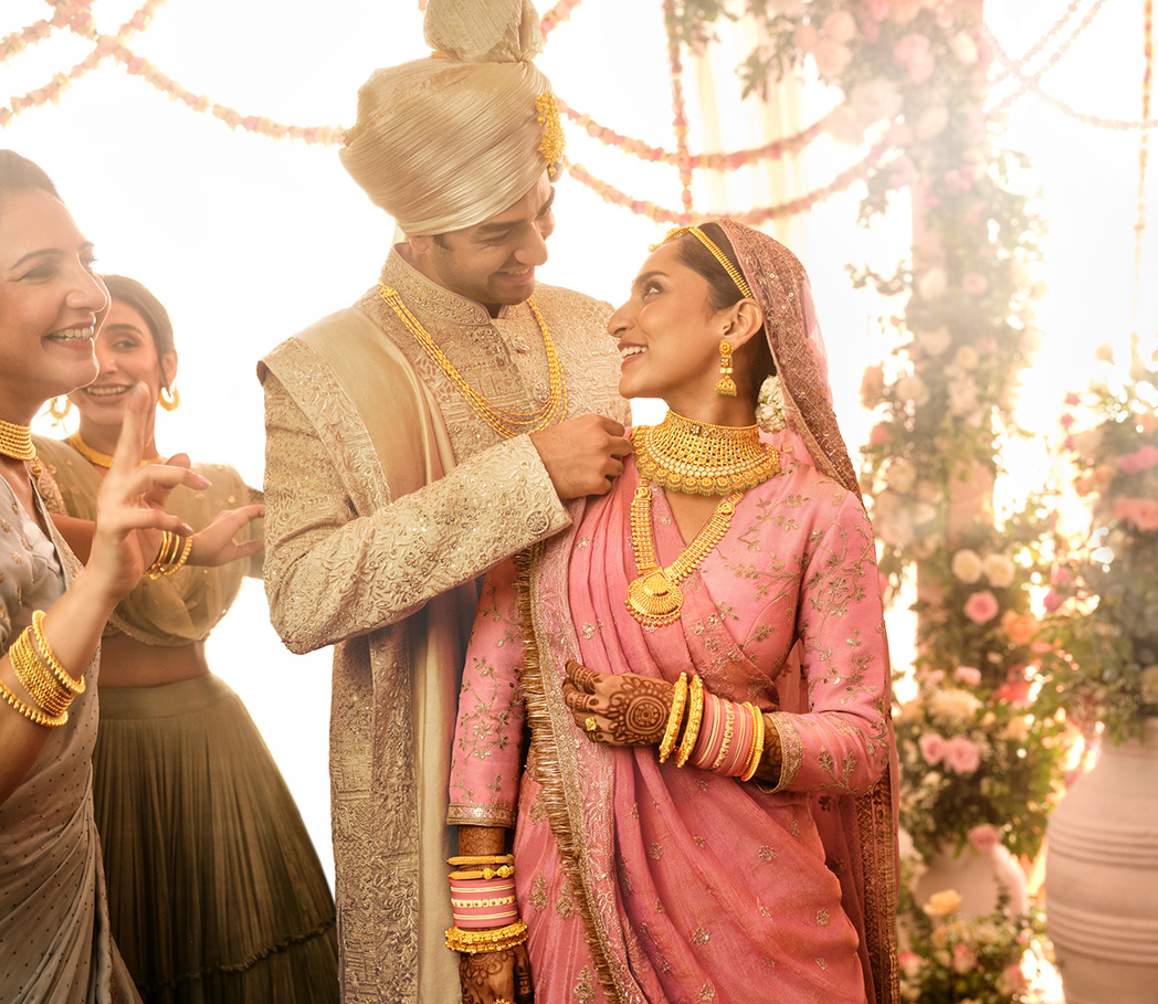 Couple on their wedding day with gold jewellery
