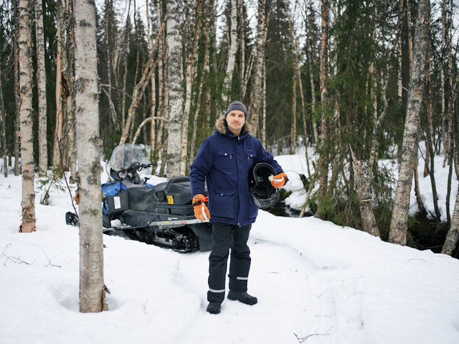 Man standing in front of a snowmobile