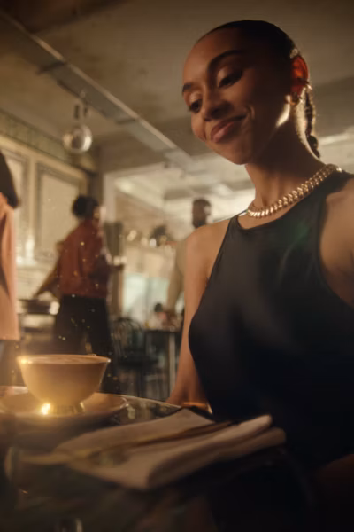 A person with a drink sitting at a bar behind text 'How Gold is different'