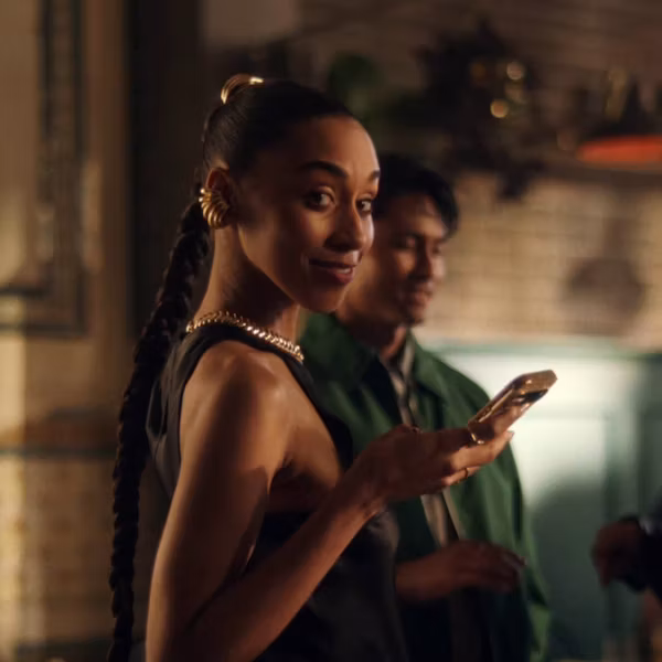 Lady with phone in hand smiling